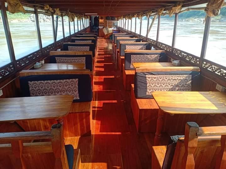 Wooden cabin seating along the slow boat aisle